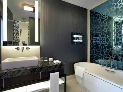a bathroom with a tub and a large mirror at Le Meridien Istanbul Etiler in Istanbul