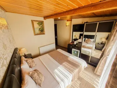 a bedroom with a bed and a mirror at Eskibağ Butik Hotel in Buyukada