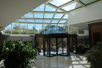 a glass revolving door in a building with windows at Paradise Island Hotel in Gebze