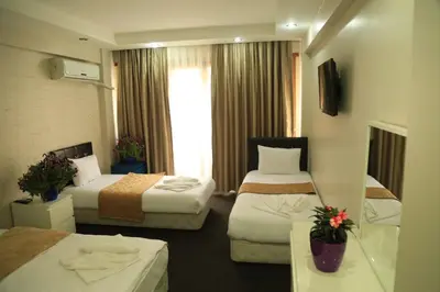 a hotel room with two beds and a window at holiday family apart in Istanbul