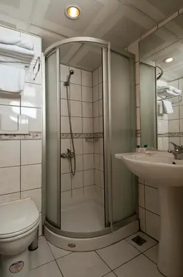 a bathroom with a shower and a toilet and a sink at Haydarpasa Hotel in Istanbul