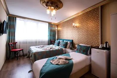 a hotel room with two beds and a window at Paris Garden Hotel Istanbul in Istanbul