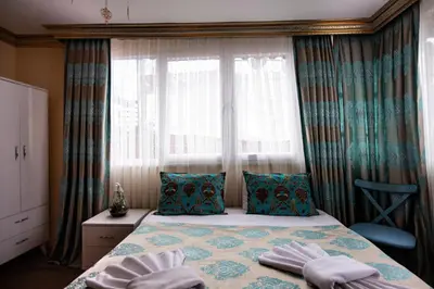 a bedroom with a bed with pillows and a window at Paris Garden Hotel Istanbul in Istanbul