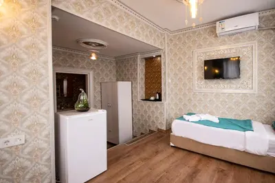 a bedroom with a bed and a tv on the wall at Paris Garden Hotel Istanbul in Istanbul