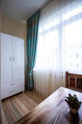 a room with a large window and a wooden table at Paris Garden Hotel Istanbul in Istanbul
