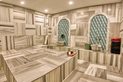 a room with a wooden floor and two windows at Sirkeci Ersu Hotel & SPA in Istanbul