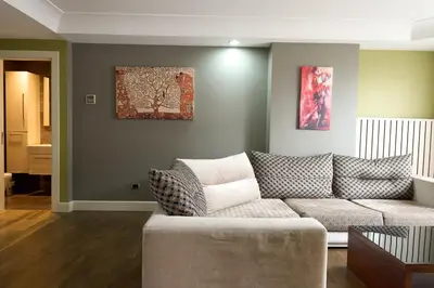 a living room with a couch and a painting on the wall at Taba Luxury Suites and Hotel in Istanbul