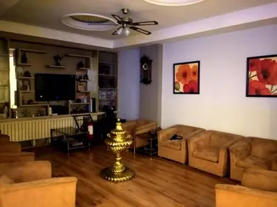 a living room with a couch and a television at Hotel Anibal in Gebze