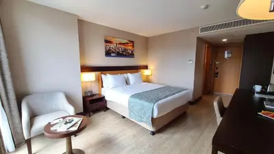a hotel room with a bed and a chair at Port Bosphorus Hotel in Istanbul