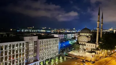a view of a city at night with a mosque at Port Bosphorus Hotel in Istanbul