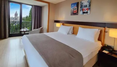 a hotel room with a large bed and a window at Port Bosphorus Hotel in Istanbul