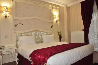 a bedroom with a large bed with a red blanket at Muyan Suites in Istanbul