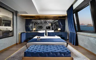 a bedroom with a large bed and a large window at The Wings Hotels Karakoy in Istanbul