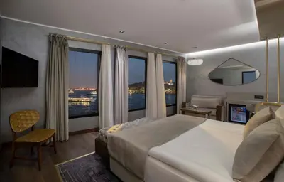 a bedroom with a large bed and a large window at The Wings Hotels Karakoy in Istanbul