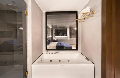a bath tub in a bathroom with a window at The Wings Hotels Karakoy in Istanbul