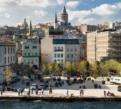 a group of people walking on a sidewalk in a city at The Wings Hotels Karakoy in Istanbul