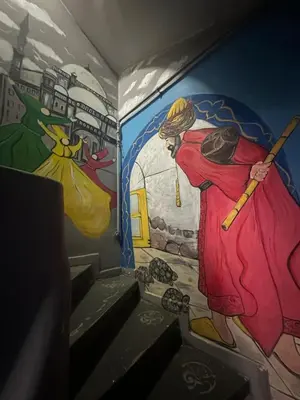 a mural of a woman with a broom in a room at Happy Suite Boutique Hotel in Istanbul