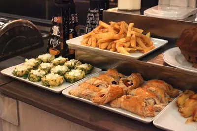 a buffet with three plates of food and french fries at Hotel Ephesus Istanbul in Istanbul
