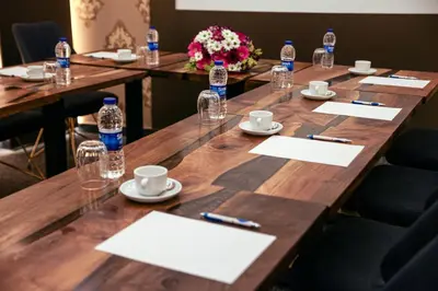 a long wooden table with bottles of water on top at Hotel Ephesus Istanbul in Istanbul