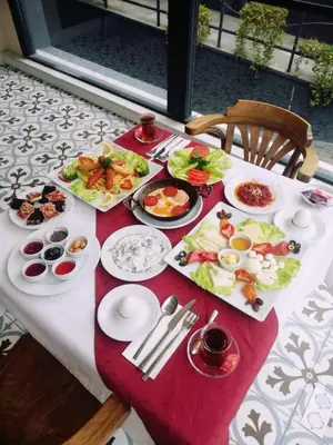 a table with plates of food on top at Bakirkoy Tashan Business & Airport Hotel in Istanbul