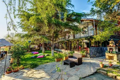 a house with a tree and a patio at Park Mandalin Hotel - Adult only in Agva