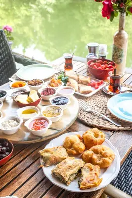 a wooden table with plates of food on it at Park Mandalin Hotel - Adult only in Agva