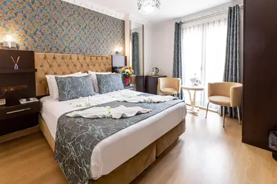 a hotel room with a large bed and a table at Kumru Hotel in Istanbul