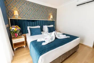 a hotel room with a large bed with shoes on it at Kumru Hotel in Istanbul