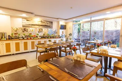 a restaurant with tables and chairs in a room at Kumru Hotel in Istanbul