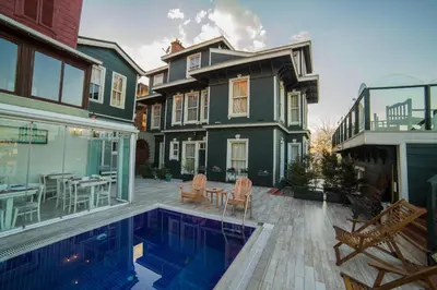 a house with a swimming pool in front of a house at HHK Hotel in Istanbul