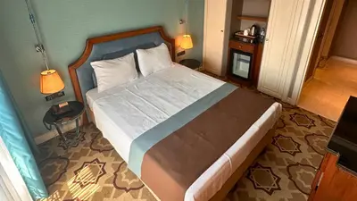 a bedroom with a large bed with a wooden frame at Grand Durmaz Hotel in Istanbul