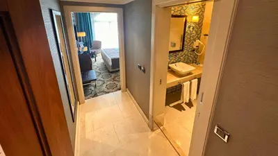 a hallway to a bathroom with a sink and a mirror at Grand Durmaz Hotel in Istanbul