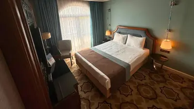 a bedroom with a bed in a room with a window at Grand Durmaz Hotel in Istanbul