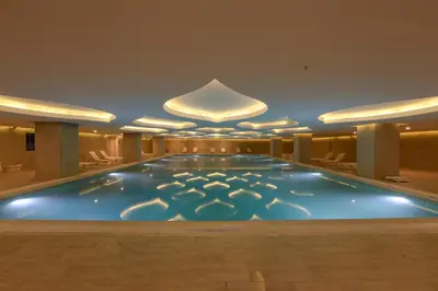 a large swimming pool in a hotel lobby at TRYP by Wyndham Izmit in Kocaeli