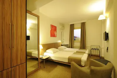 a hotel room with a bed and a mirror at Kardes Hotel in Bursa