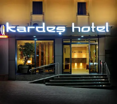 a store front of a hotel with a neon sign at Kardes Hotel in Bursa