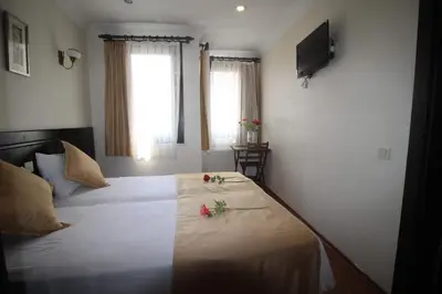 a bedroom with a bed with flowers on it at Sultans Hotel in Istanbul