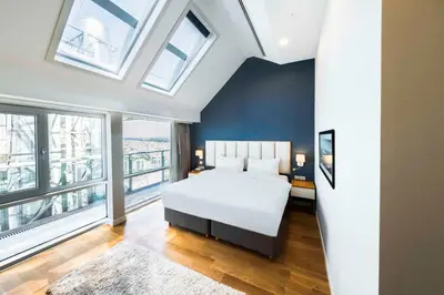 a bedroom with a white bed and windows at Radisson Residences Avrupa TEM Istanbul in Istanbul