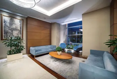 a living room with blue couches and a table at Radisson Residences Avrupa TEM Istanbul in Istanbul