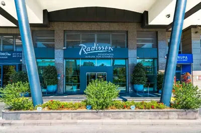 a building with blue columns in front of it at Radisson Residences Avrupa TEM Istanbul in Istanbul
