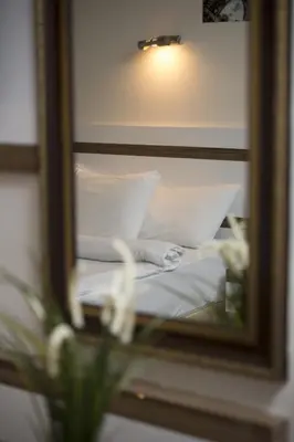 a reflection of a bed in a mirror at Ceylan Hotel in Bursa