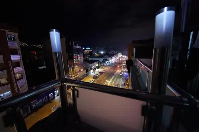 a view of a city street at night from a balcony at Ceylan Hotel in Bursa