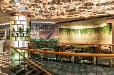 a restaurant with a bar with green stools at Opera Hotel Bosphorus - Preferred Hotels and Resorts in Istanbul