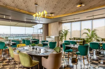 a restaurant with tables and chairs and large windows at Opera Hotel Bosphorus - Preferred Hotels and Resorts in Istanbul