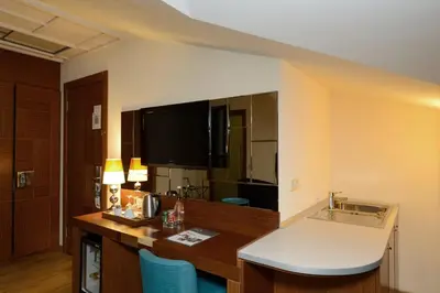 a hotel room with a desk and a large mirror at Collage Pera Hotel in Istanbul