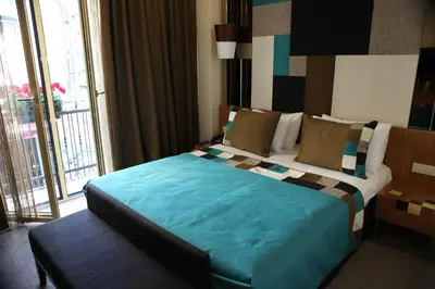 a bedroom with a large bed with a large window at Collage Pera Hotel in Istanbul