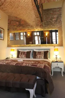 a bedroom with a large bed in a room with windows at Collage Pera Hotel in Istanbul