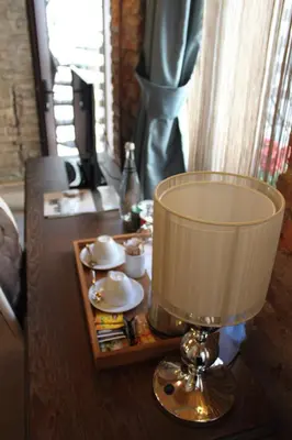 a table with a lamp on top of a table at Collage Pera Hotel in Istanbul