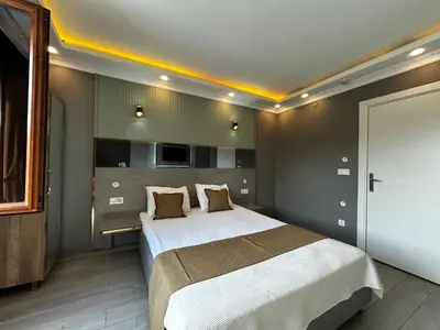 a bedroom with a large bed in a room at Sahrakent Otel Ataşehir in Istanbul