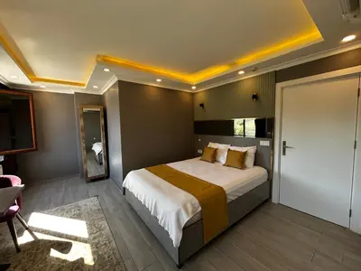 a bedroom with a large bed in a room at Sahrakent Otel Ataşehir in Istanbul